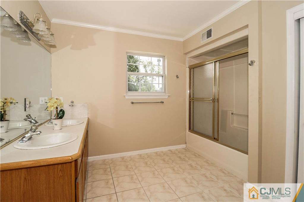1 Daniel Road Edison, NJ 08820 - Photo 22 of 24 a bathroom with a sink and a mirror