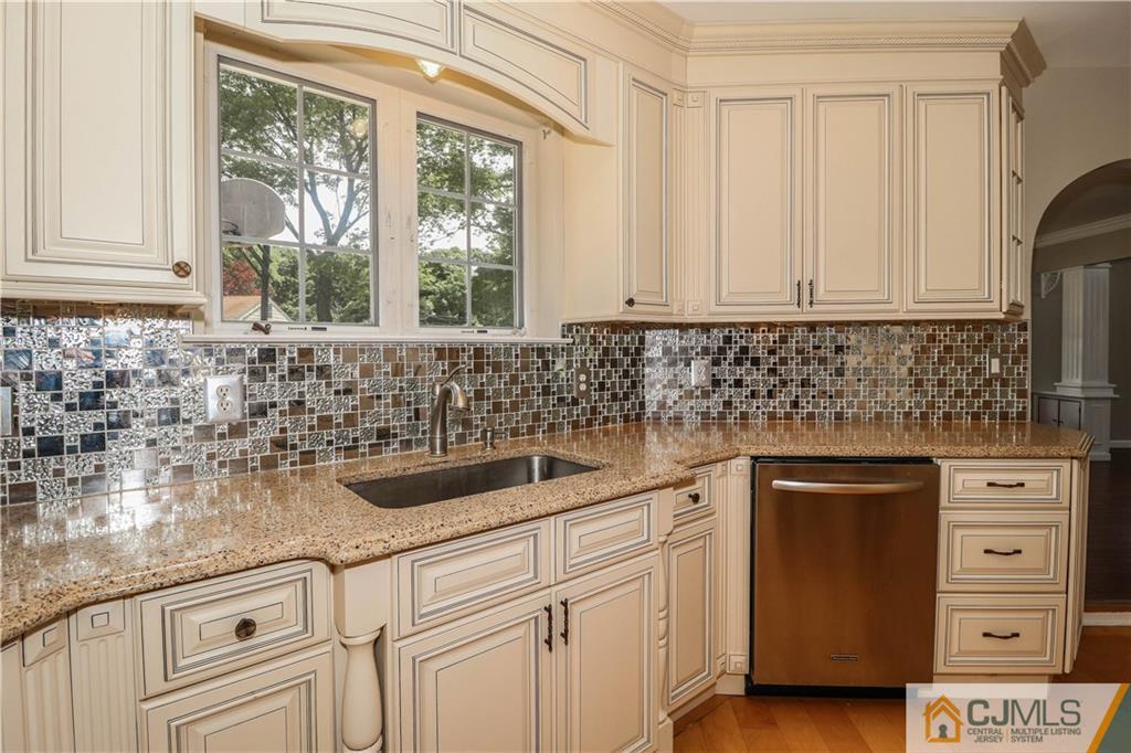 1 Daniel Road Edison, NJ 08820 - Photo 8 of 24 a kitchen with cabinets appliances a sink and a window