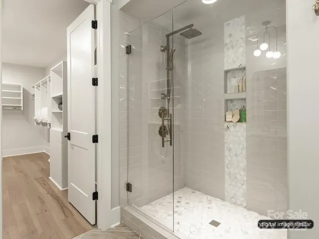 a bathroom with a shower and a bath tub