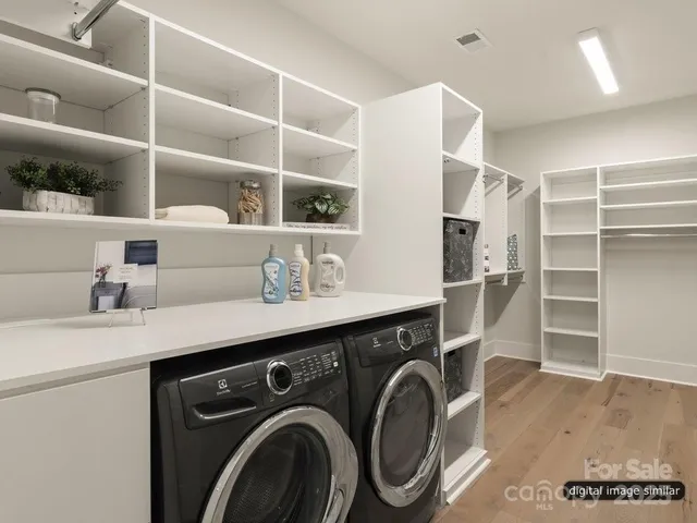 a utility room with cabinets dryer and washer