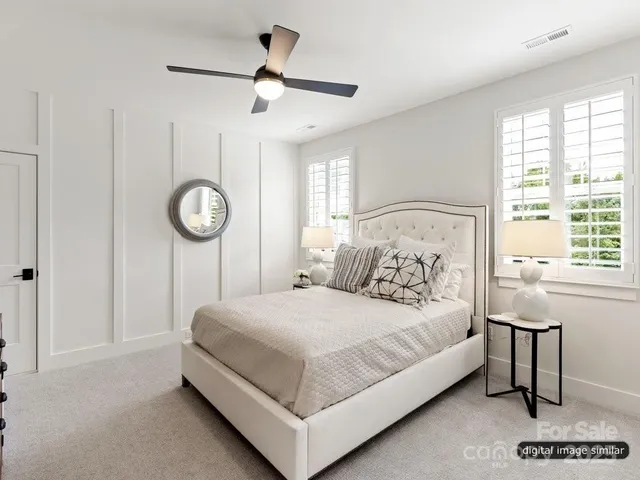 a bedroom with a bed a window and a chandelier