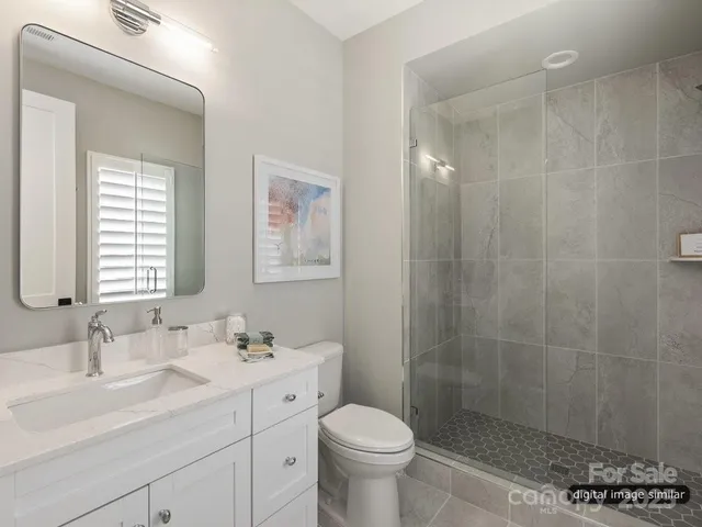 a bathroom with a sink toilet a mirror and shower