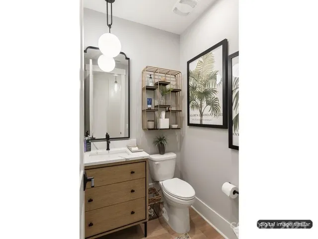 a bathroom with a toilet a sink a mirror and a shower