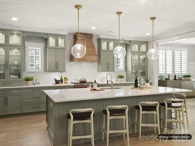 a kitchen with center island cabinets and chairs in it