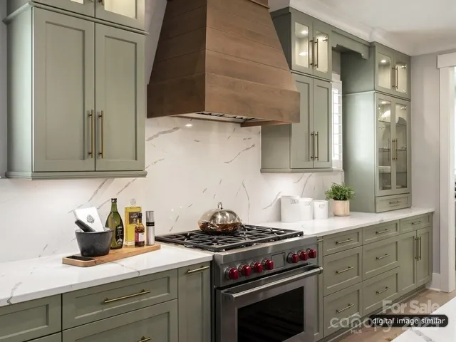 a kitchen with stainless steel appliances granite countertop a stove and a refrigerator