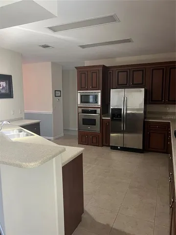 a kitchen with stainless steel appliances a refrigerator and a stove