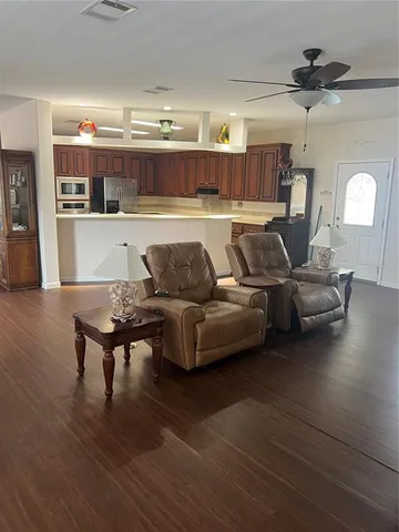 a living room with furniture and a wooden floor