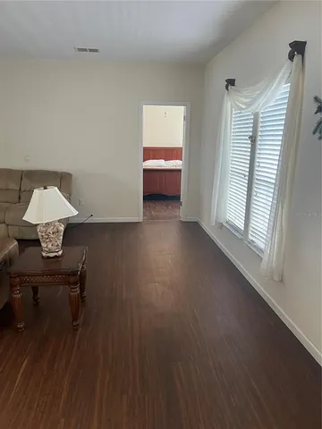 a view of workspace and wooden floor in a room