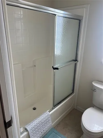 a bathroom with a shower and a toilet