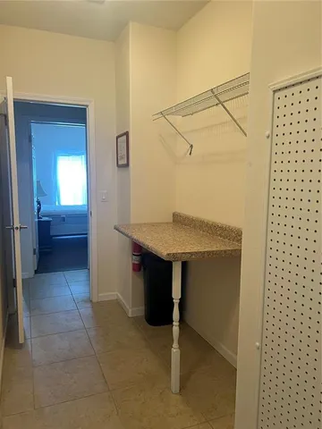 a view of kitchen with sink and refrigerator