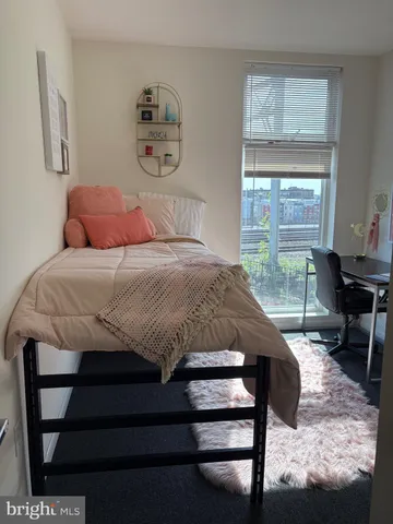 a bedroom with a bed and a table in it