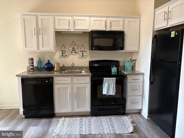 a kitchen with appliances and cabinets