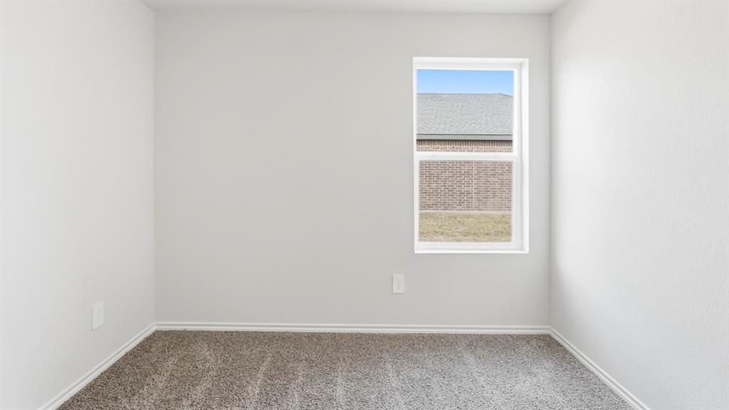 3319 Twilight Trail Forney, TX 75126 - Photo 30 of 33 Neutral-toned walls complement plush carpet flooring
