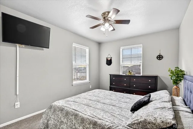 a bedroom with bed and a window