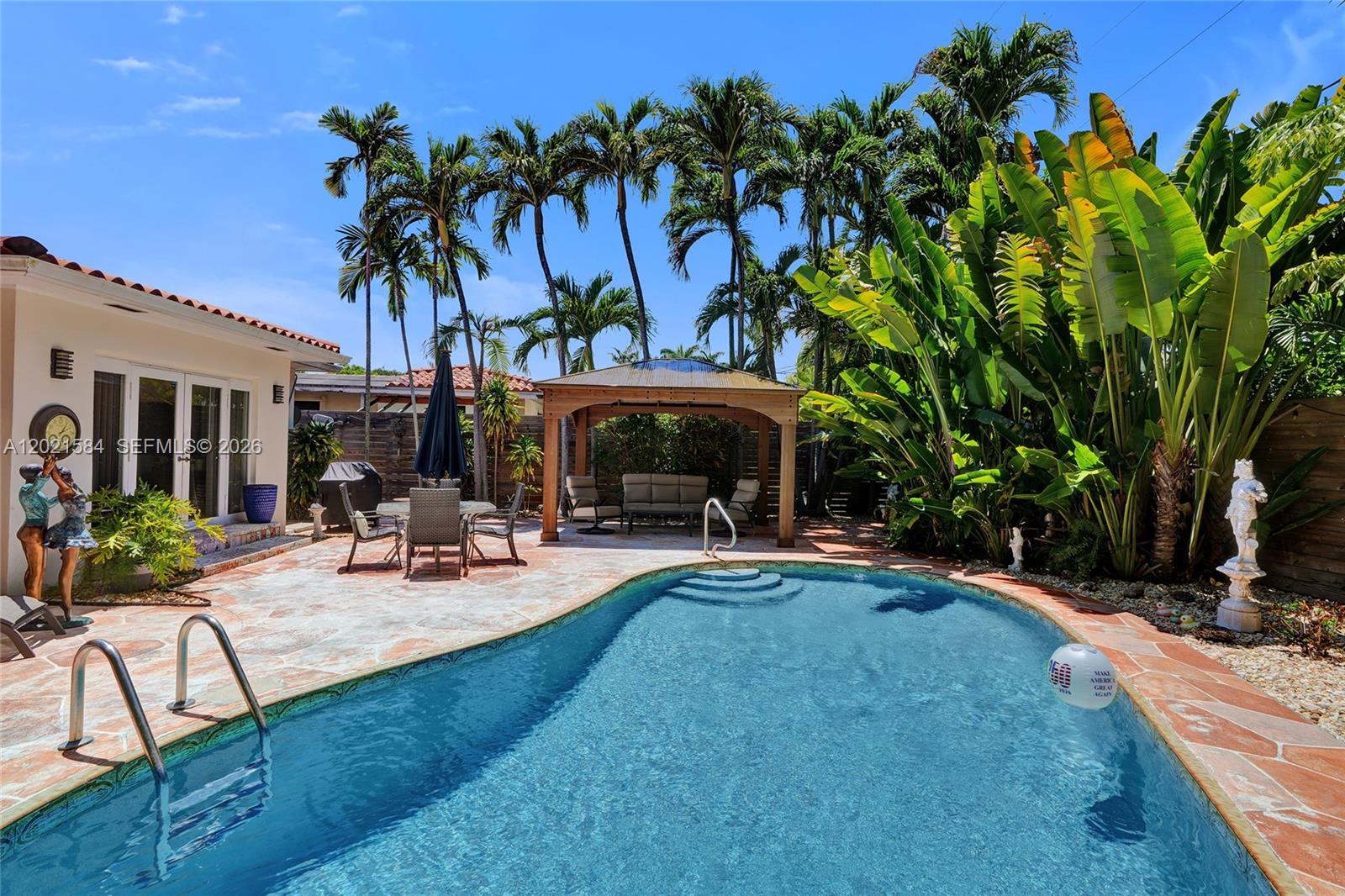 811 Northeast 73rd Street Miami, FL 33138 - Photo 24 of 51 a view of a backyard with a patio and swimming pool