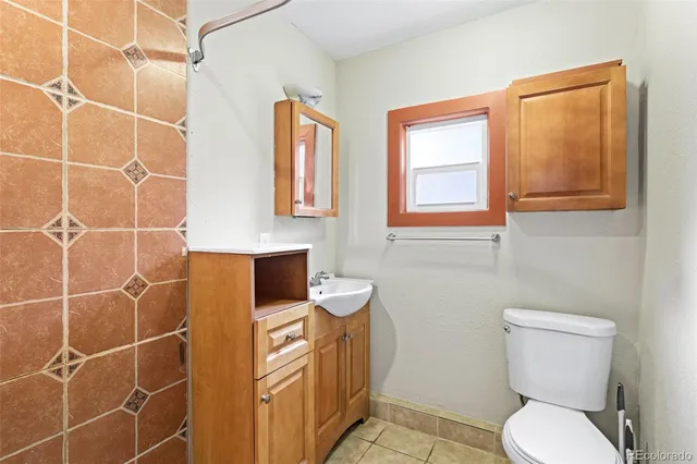 a bathroom with a toilet a sink and a shower