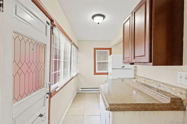 a view of a kitchen with stainless steel appliances granite countertop furniture and a window