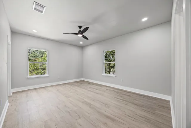 wooden floor in an empty room with a window