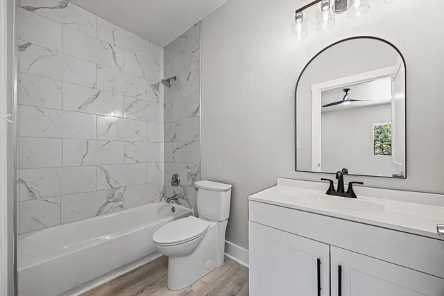 a bathroom with a sink a toilet and a mirror