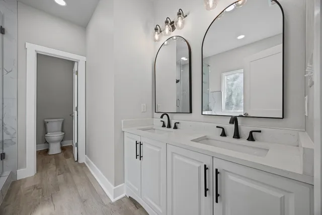 a bathroom with a double vanity sink and a mirror