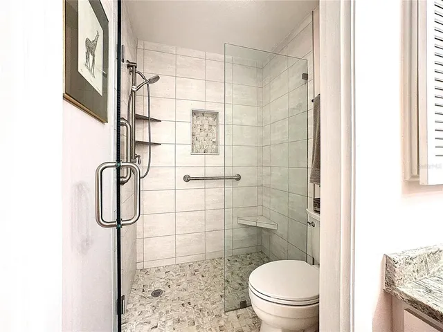 a bathroom with a glass shower door
