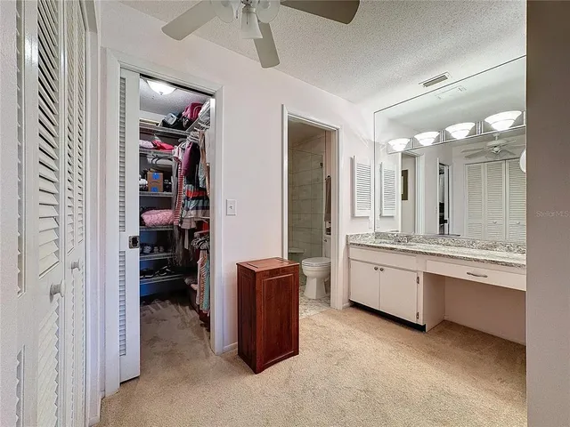 a large bathroom with a large mirror vanity and shower