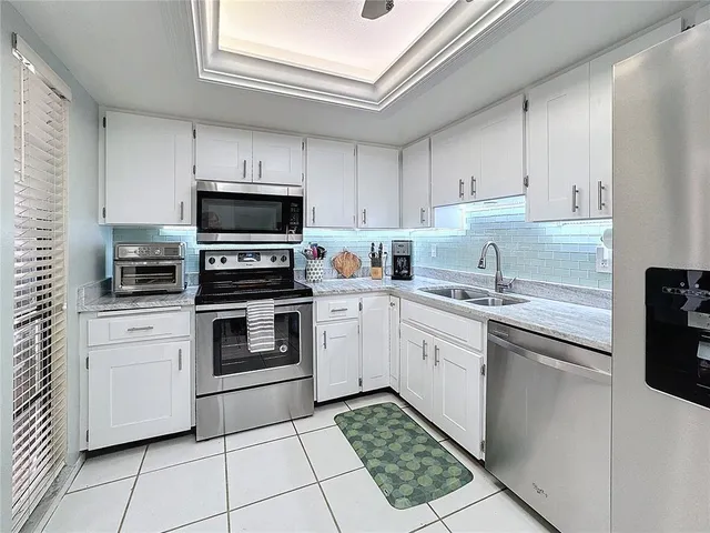 a kitchen with a stove sink and a microwave