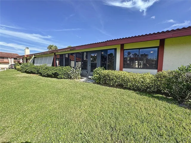 a front view of house with yard and green space