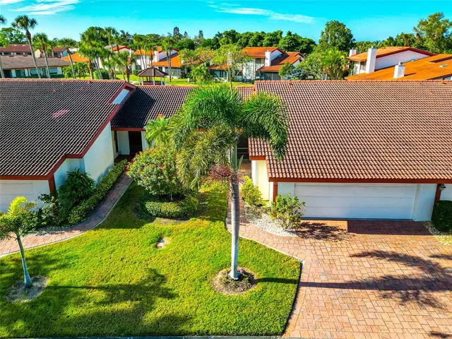 an aerial view of a house with a yard and lake view