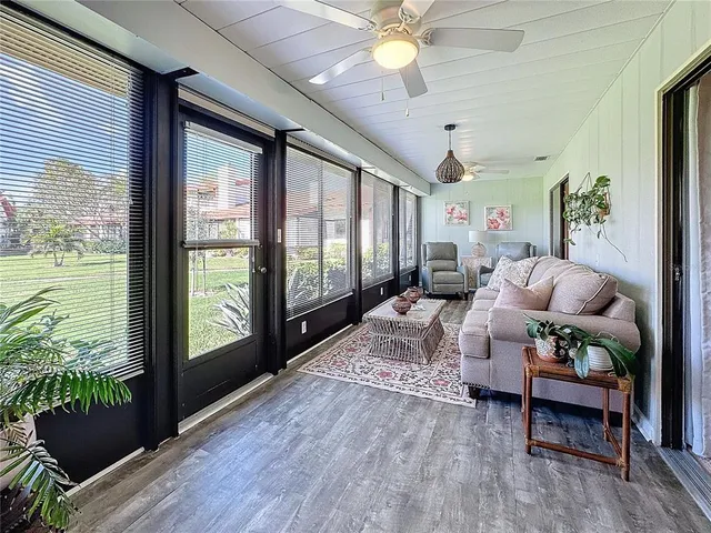 a living room with furniture and a large window with outer view