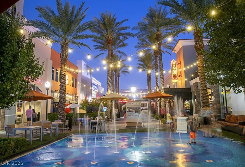1140 Julie Road Henderson, NV 89002 - Photo 26 of 38 The District, an inviting community hub features a lively splash pad and al fresco dining under strings of festive lights.
