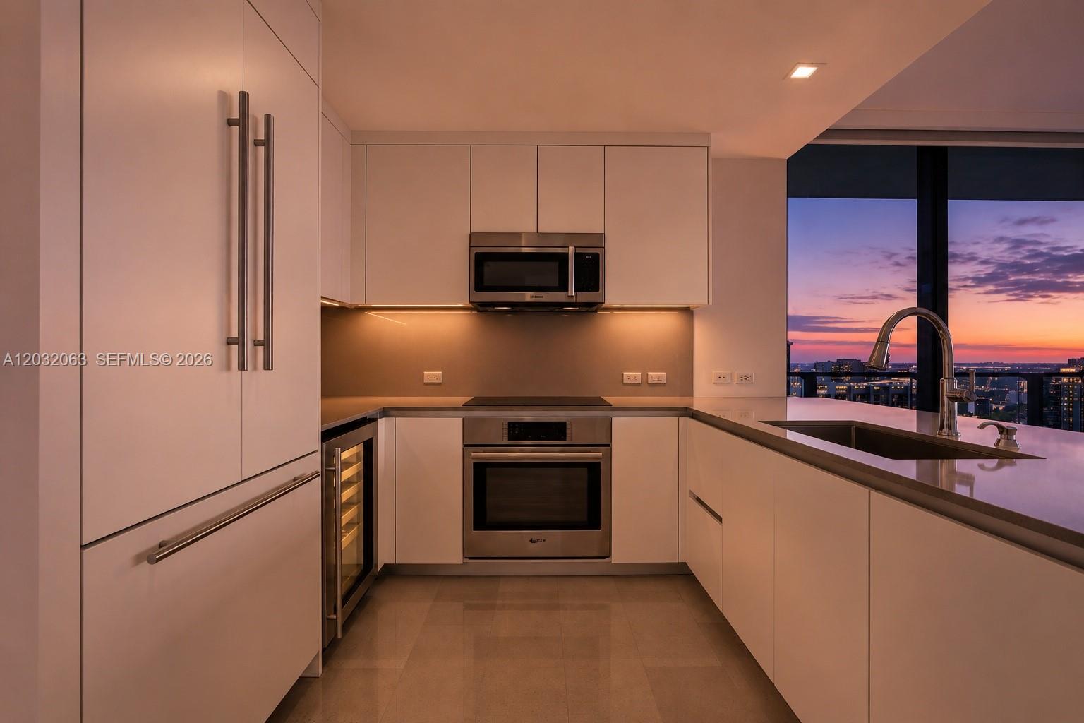 88 Southwest 7th Street, Unit 2302 Miami, FL 33130 - Photo 6 of 26 a kitchen with stainless steel appliances a refrigerator sink and microwave