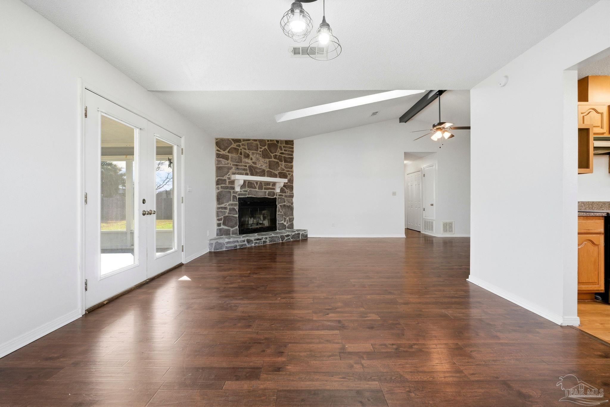 3228 Copper Ridge Circle Cantonment, FL 32533 - Photo 11 of 38 a view of an empty room with wooden floor fireplace and a window