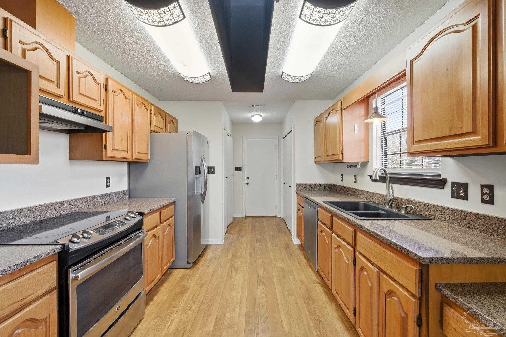 3228 Copper Ridge Circle Cantonment, FL 32533 - Photo 13 of 38 a kitchen with stainless steel appliances granite countertop a stove and a sink