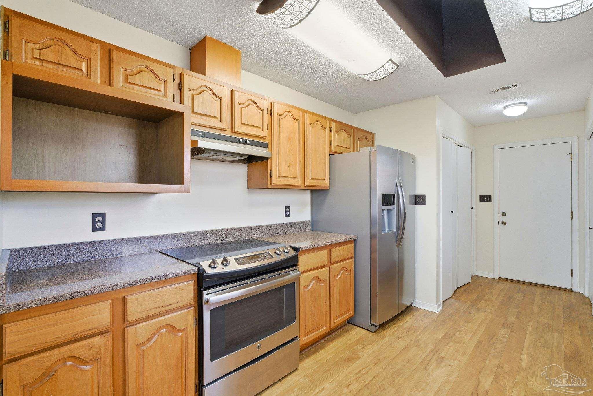 3228 Copper Ridge Circle Cantonment, FL 32533 - Photo 14 of 38 a kitchen with stainless steel appliances granite countertop a stove and a refrigerator