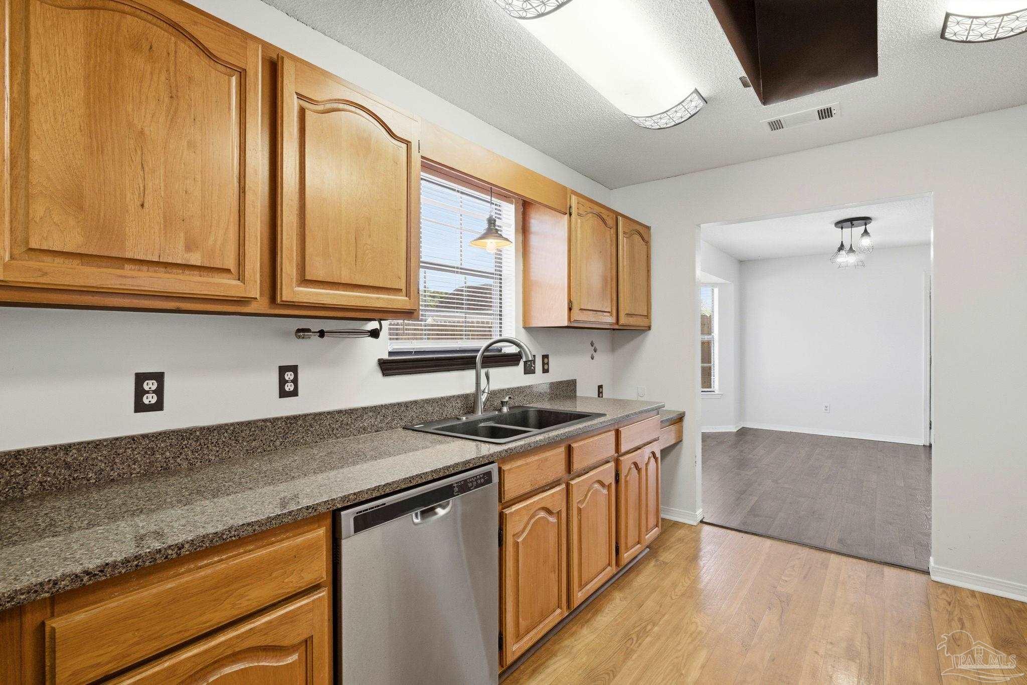 3228 Copper Ridge Circle Cantonment, FL 32533 - Photo 17 of 41 a kitchen with stainless steel appliances granite countertop a sink stove and cabinets