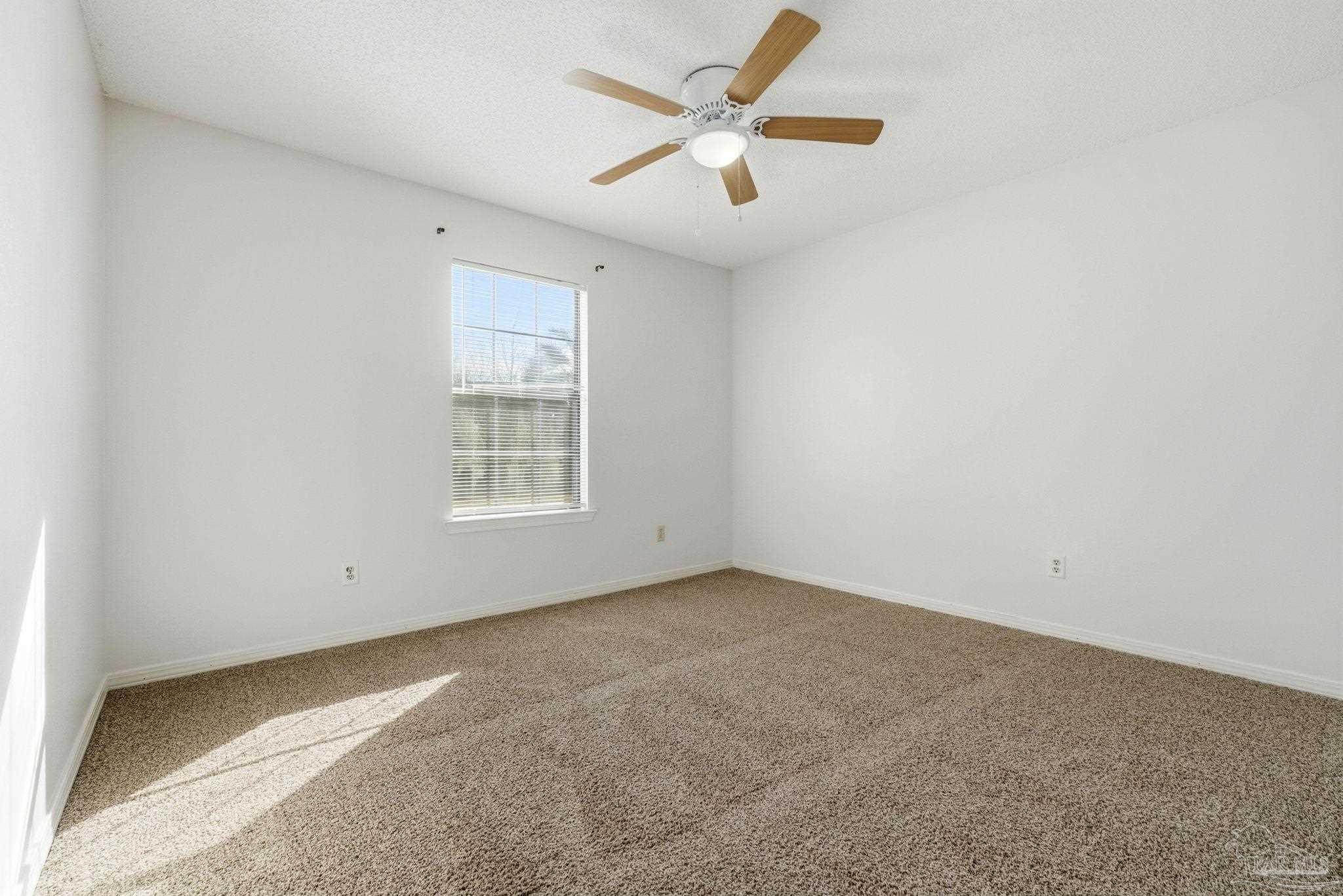 3228 Copper Ridge Circle Cantonment, FL 32533 - Photo 19 of 38 an empty room with a window and a fan