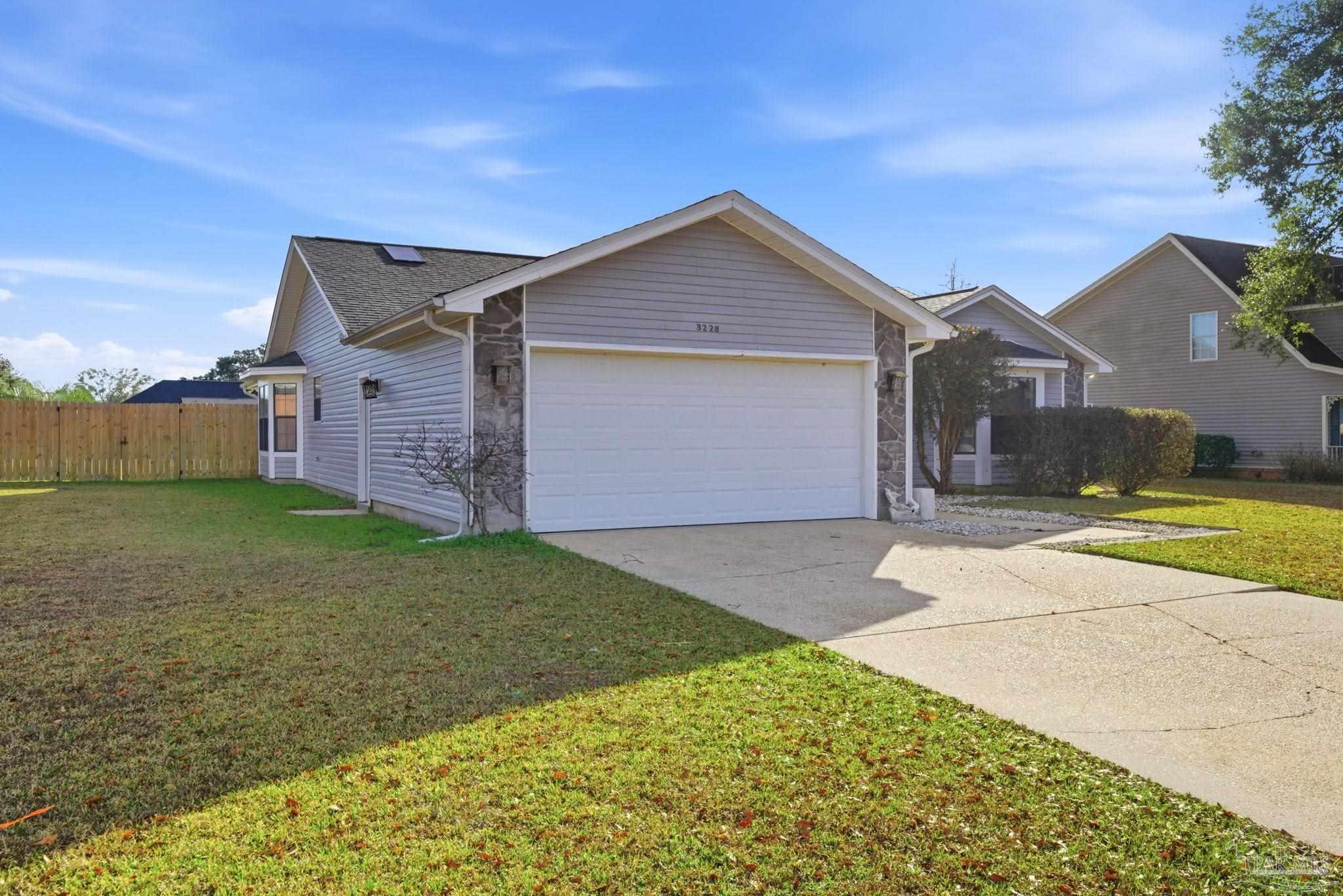 3228 Copper Ridge Circle Cantonment, FL 32533 - Photo 2 of 38 a front view of a house with a yard and garage