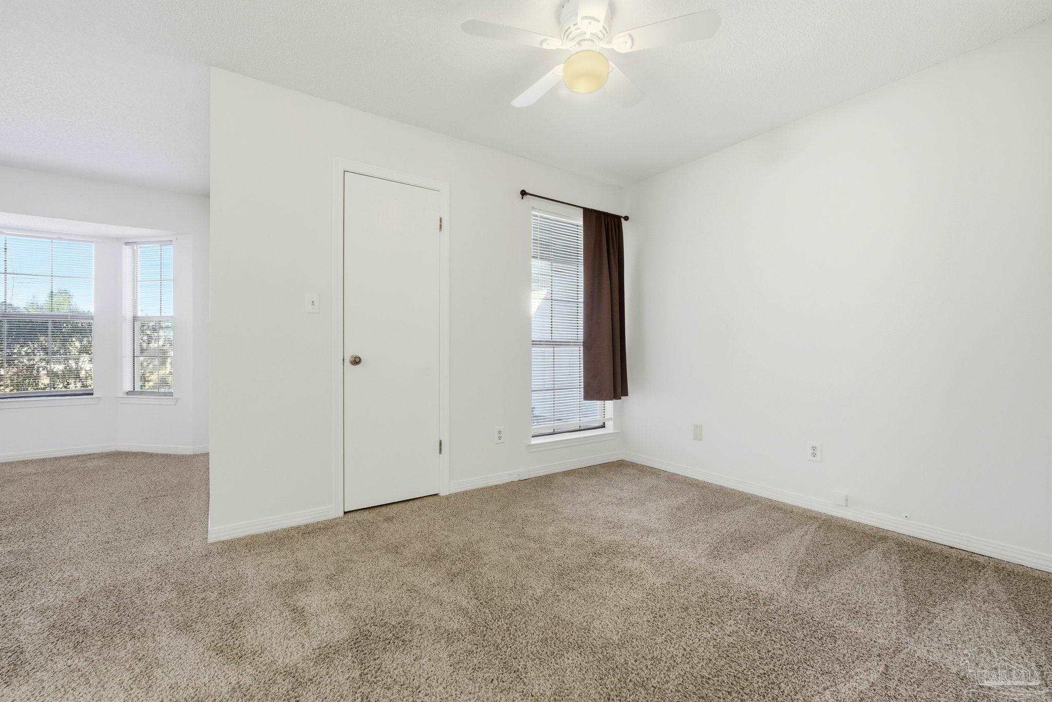 3228 Copper Ridge Circle Cantonment, FL 32533 - Photo 24 of 38 an empty room with windows and fan