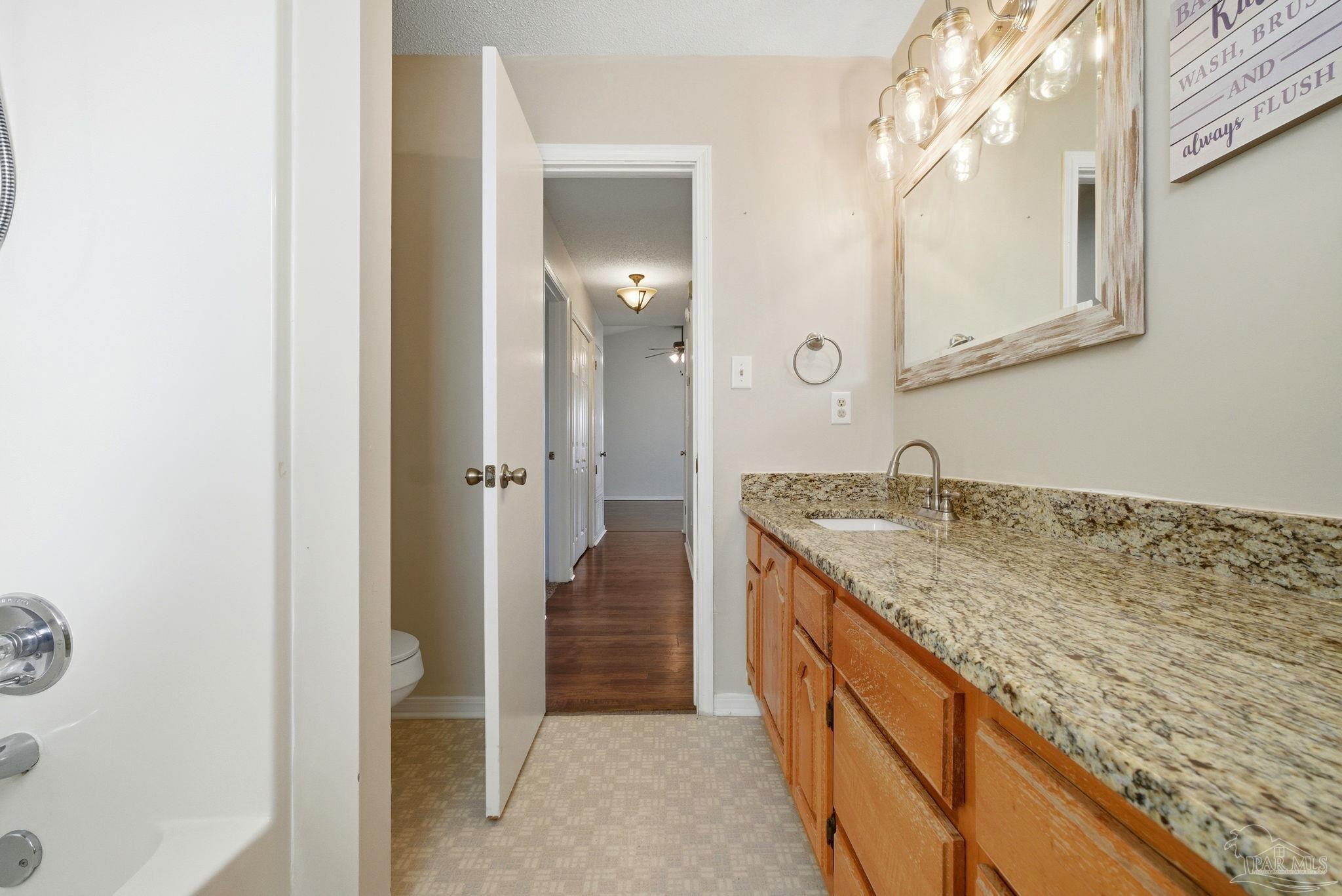 3228 Copper Ridge Circle Cantonment, FL 32533 - Photo 24 of 41 a bathroom with a granite countertop sink and a mirror