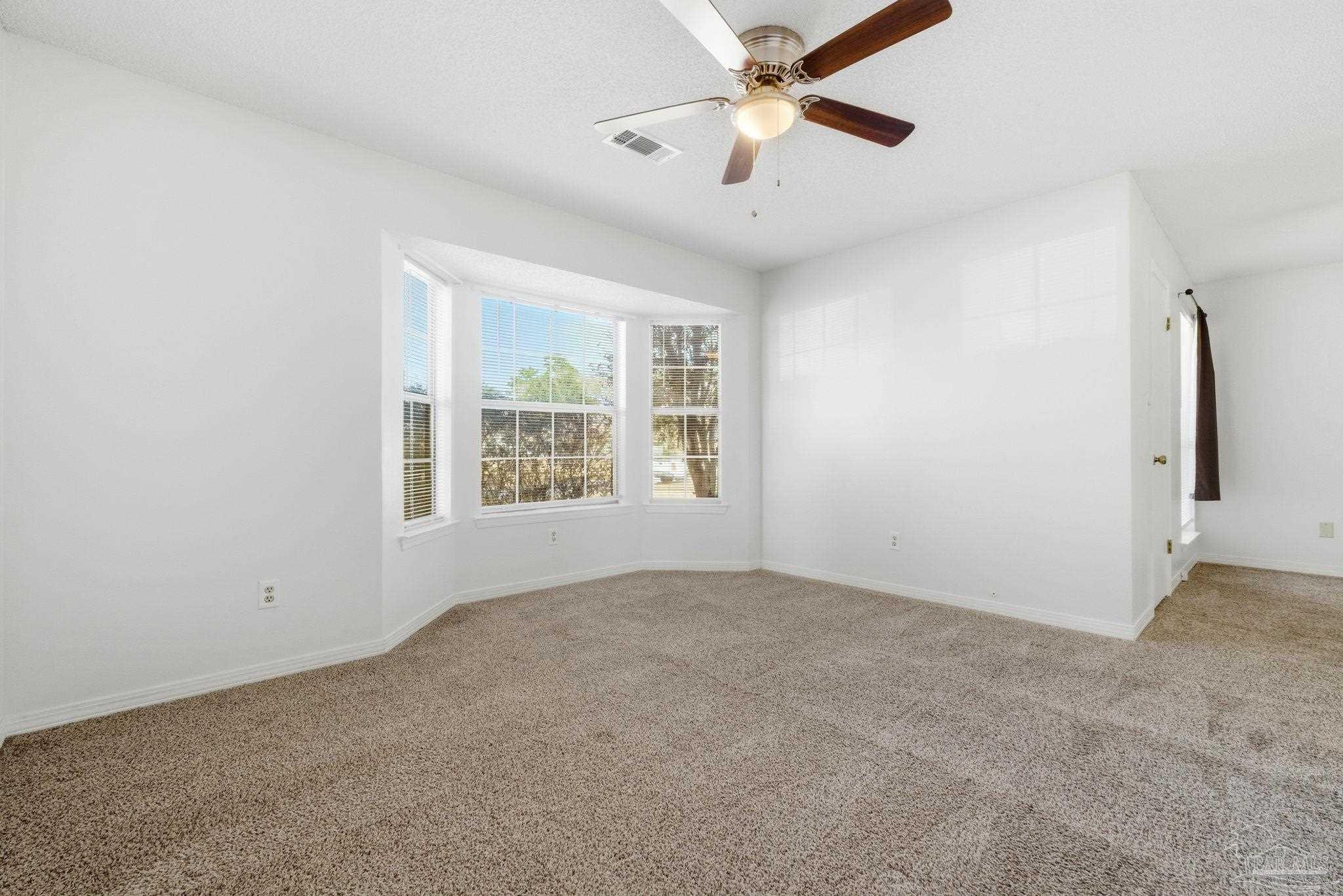 3228 Copper Ridge Circle Cantonment, FL 32533 - Photo 27 of 38 an empty room with windows and fan