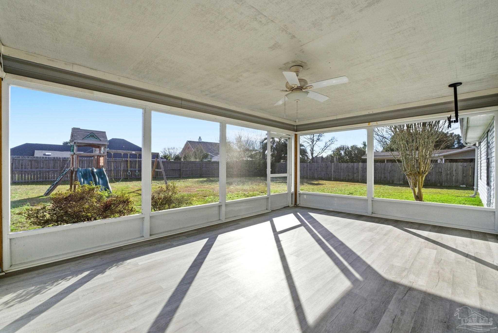 3228 Copper Ridge Circle Cantonment, FL 32533 - Photo 33 of 38 a view of an empty room with wooden floor and windows