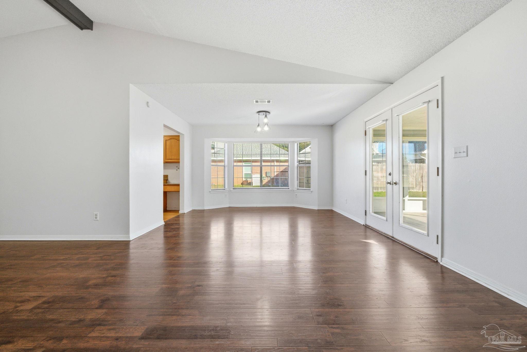 3228 Copper Ridge Circle Cantonment, FL 32533 - Photo 9 of 38 an empty room with wooden floor and windows