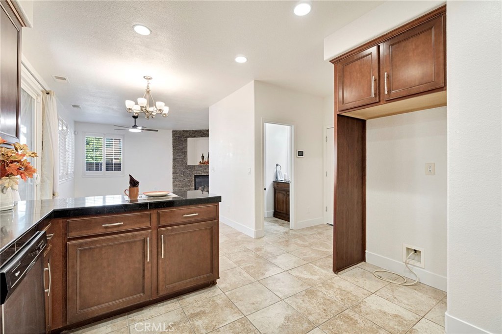 692 Blueberry Lane Madera, CA 93638 - Photo 16 of 44 a kitchen with granite countertop a refrigerator and a sink