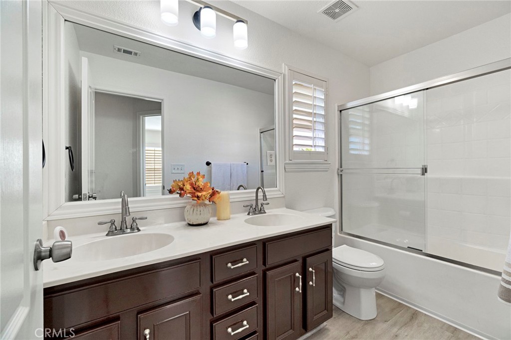 692 Blueberry Lane Madera, CA 93638 - Photo 22 of 44 a bathroom with a sink double vanity and a toilet