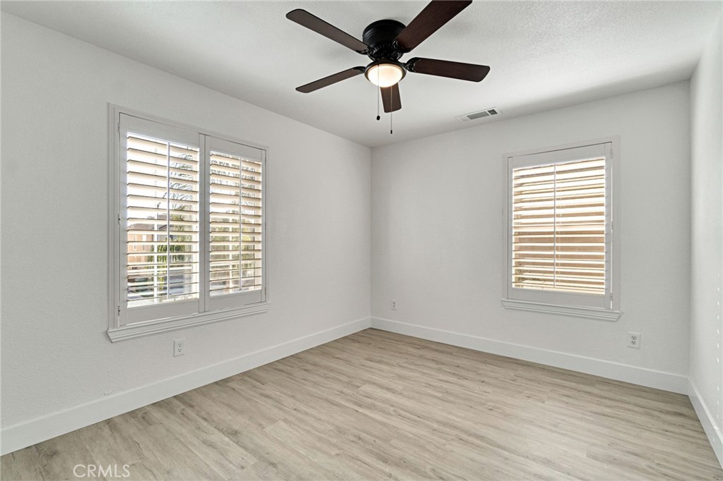 692 Blueberry Lane Madera, CA 93638 - Photo 23 of 44 a view of an empty room with wooden floor and a window