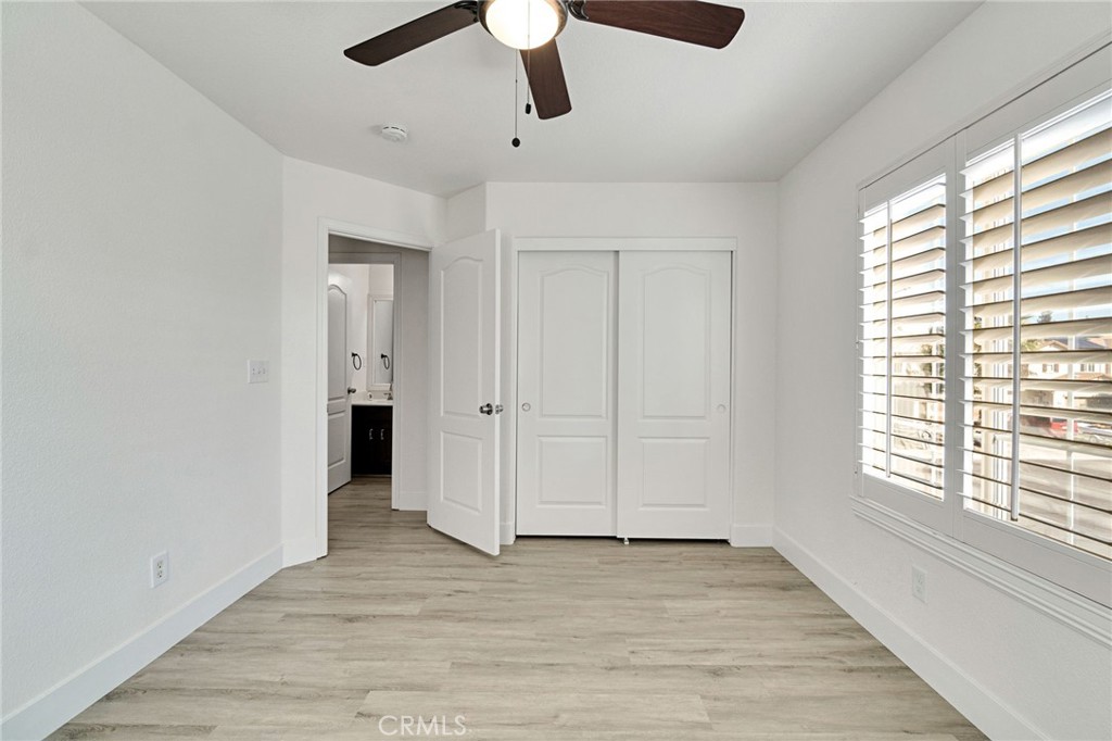 692 Blueberry Lane Madera, CA 93638 - Photo 24 of 44 a view of an empty room with wooden floor and a window