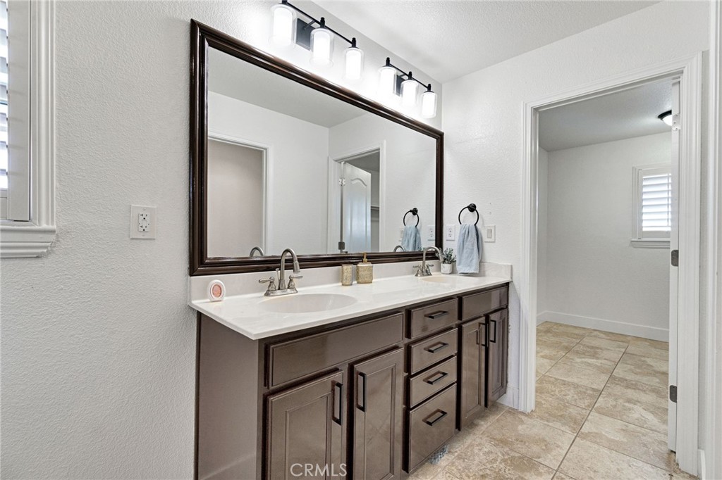 692 Blueberry Lane Madera, CA 93638 - Photo 32 of 44 a bathroom with a sink a mirror and a vanity