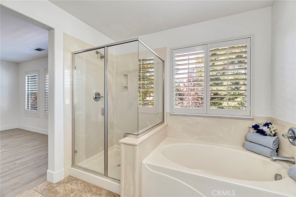 692 Blueberry Lane Madera, CA 93638 - Photo 33 of 44 a white bath tub sitting next to a shower