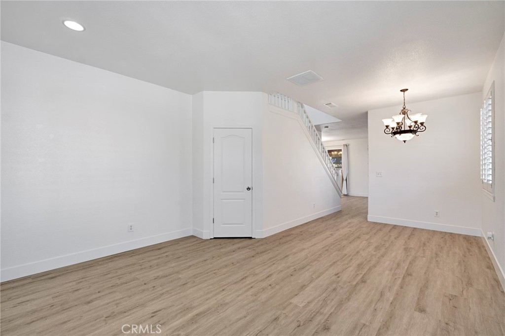 692 Blueberry Lane Madera, CA 93638 - Photo 4 of 44 wooden floor in an empty room with a window